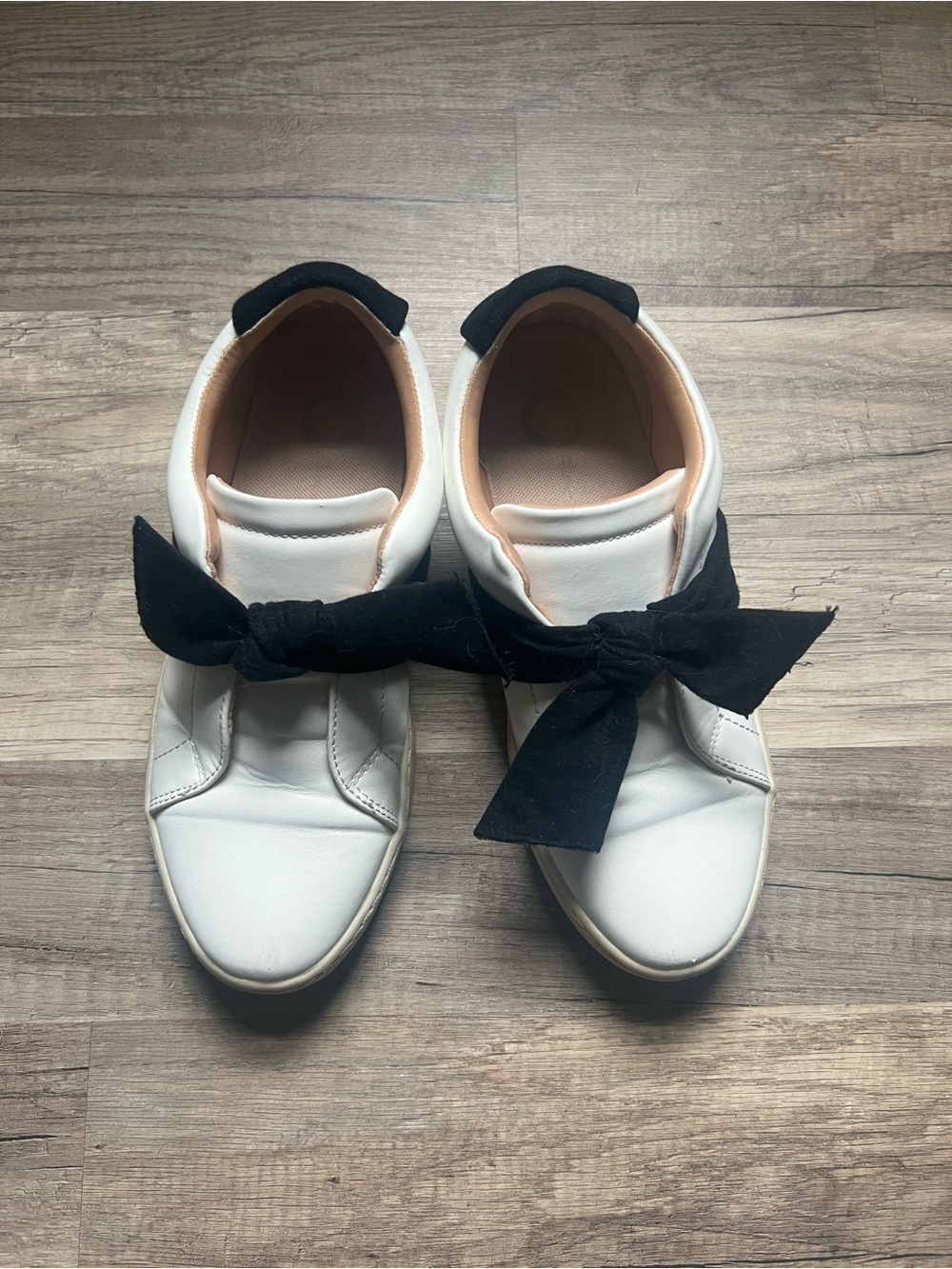 Women’s White Slip-On Sneakers with Black Bow Accent
